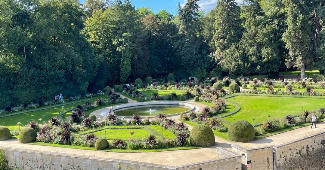 planning a trip to France formal garden with fountain in middle